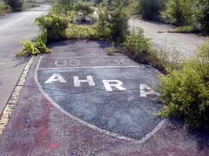 The AHRA logo painted on the pavement between the twin tracks just past the starting line.