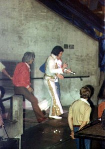Elvis Presley walks onto the stage for the last time. 
