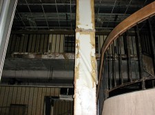 sheraton13large A curved staircase leads to the mezzanine level meeting rooms. The red-paneled front desk is partially visible.