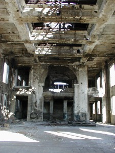 The massive main hall, looking from the front doorway. The glass skylights are gone, as are all of the windows and doors.