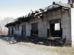 station9large The loading docks on the North end of the express freight building. It is possible that a spur line was once here, as the ground is littered with track ballast.