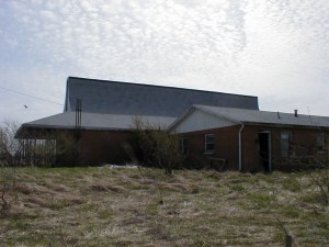 The house behind. It is attached through a storage room between it and the store.